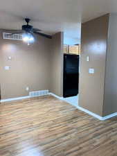 Spare room featuring light wood finished floors and ceiling fan