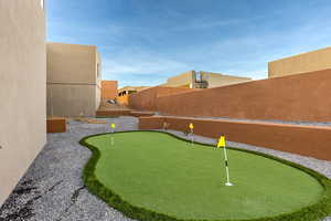 View of yard featuring a putting area