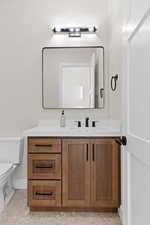 Half bathroom with vanity and toilet