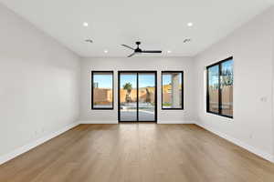 Empty room with light wood-style flooring, a ceiling fan, and recessed lighting
