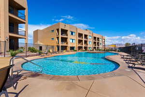 Community pool with a patio