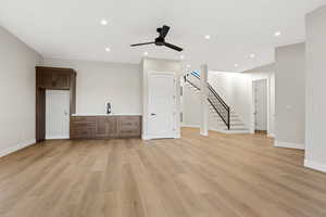 Unfurnished living room with a ceiling fan, light wood finished floors, and recessed lighting