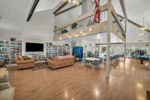 Living area with a ceiling fan and wood finished floors