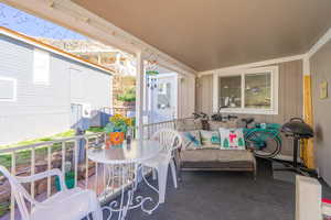 Sunroom / solarium featuring an outdoor living / dining area