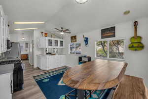 Dining space with light wood-style flooring and ceiling fan