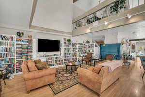 Living area featuring a high ceiling and wood finished floors
