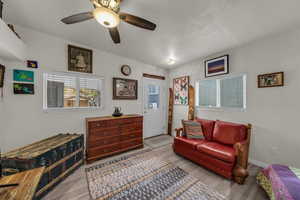 Sitting room featuring ceiling fan and light wood-style floors
