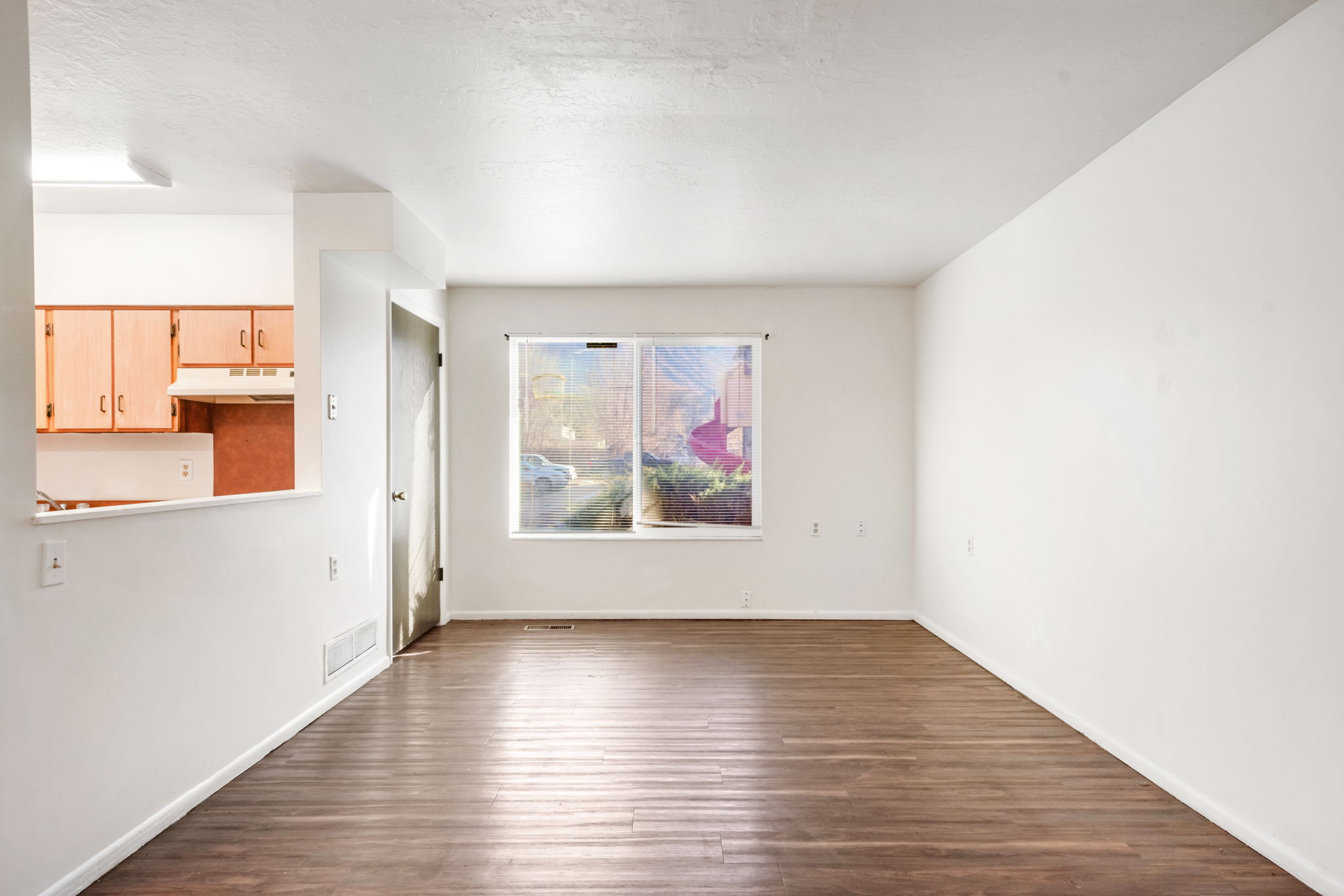 Unfurnished dining area with dark wood-style flooring and baseboards
