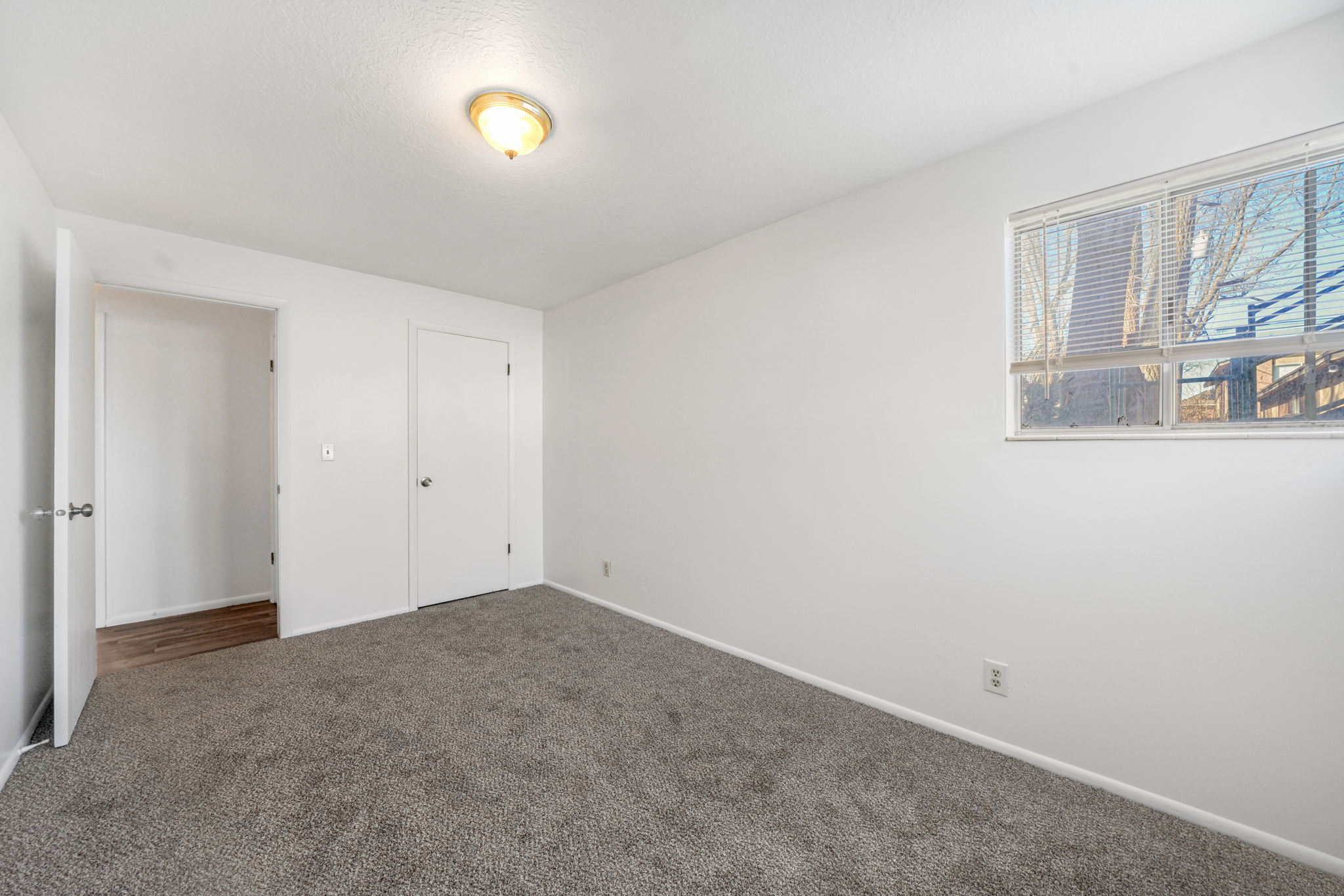 Unfurnished bedroom featuring baseboards and dark colored carpet