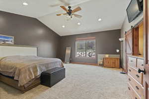 Primary Bedroom with vaulted ceiling, recessed lighting, light carpet, a barn door, and ceiling fan