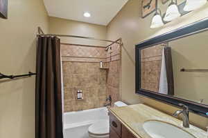 Bathroom featuring vanity and shower / tub combo