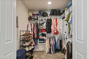 Walk in closet with light carpet