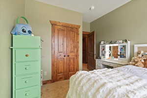 Bedroom featuring light colored carpet and a closet