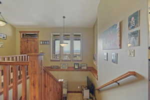 Wide Stairway featuring carpet flooring