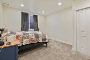 Bedroom featuring light carpet and recessed lighting