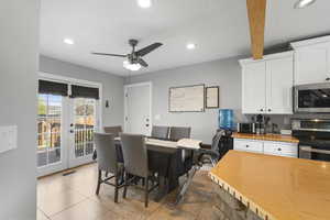 Dining room featuring recessed lighting, ceiling fan, light tile patterned floors, and french doors