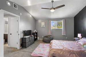 Bedroom with light colored carpet and a ceiling fan