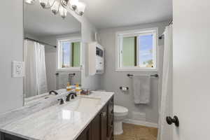 Bathroom featuring vanity, a shower with curtain, and light tile patterned flooring