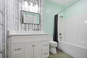 Full bathroom with vanity, shower / bath combo