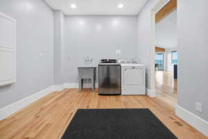 Laundry room featuring recessed lighting, light wood floors