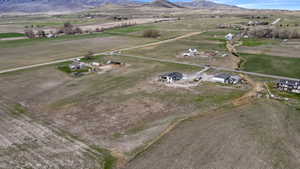Aerial view of property's location with rural landscape and a mountainous background