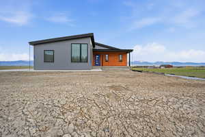 Front view of property featuring a mountain view and covered porch