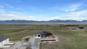 View of mountain backdrop with rural landscape