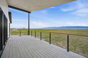 Deck with a view of countryside and a mountain view