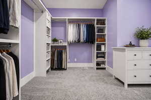 Virtually staged Owner's bedroom walk in closet