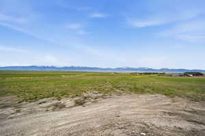 View of mountain backdrop featuring rural landscape