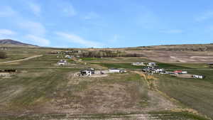Aerial view of property's location with rural landscape and a mountain backdrop