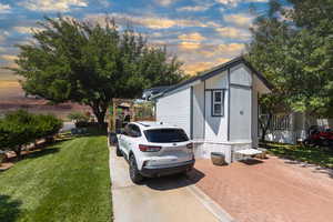 Outdoor structure at dusk with a yard