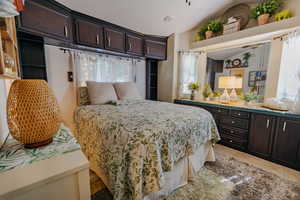 Bedroom featuring light colored carpet and lofted ceiling