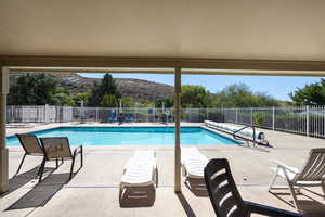 Community pool featuring a patio area and a mountain view