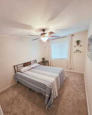 Bedroom featuring carpet floors, a textured ceiling, and a ceiling fan