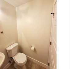 Bathroom with baseboards and toilet