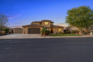 Mediterranean / spanish-style house with a gate, stucco siding, an attached garage, a tile roof, and concrete driveway
