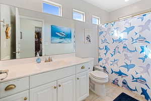 Full bathroom with a shower with curtain, vanity, and light tile patterned floors