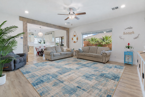 Living area featuring a ceiling fan, light wood-style floors, and recessed lighting