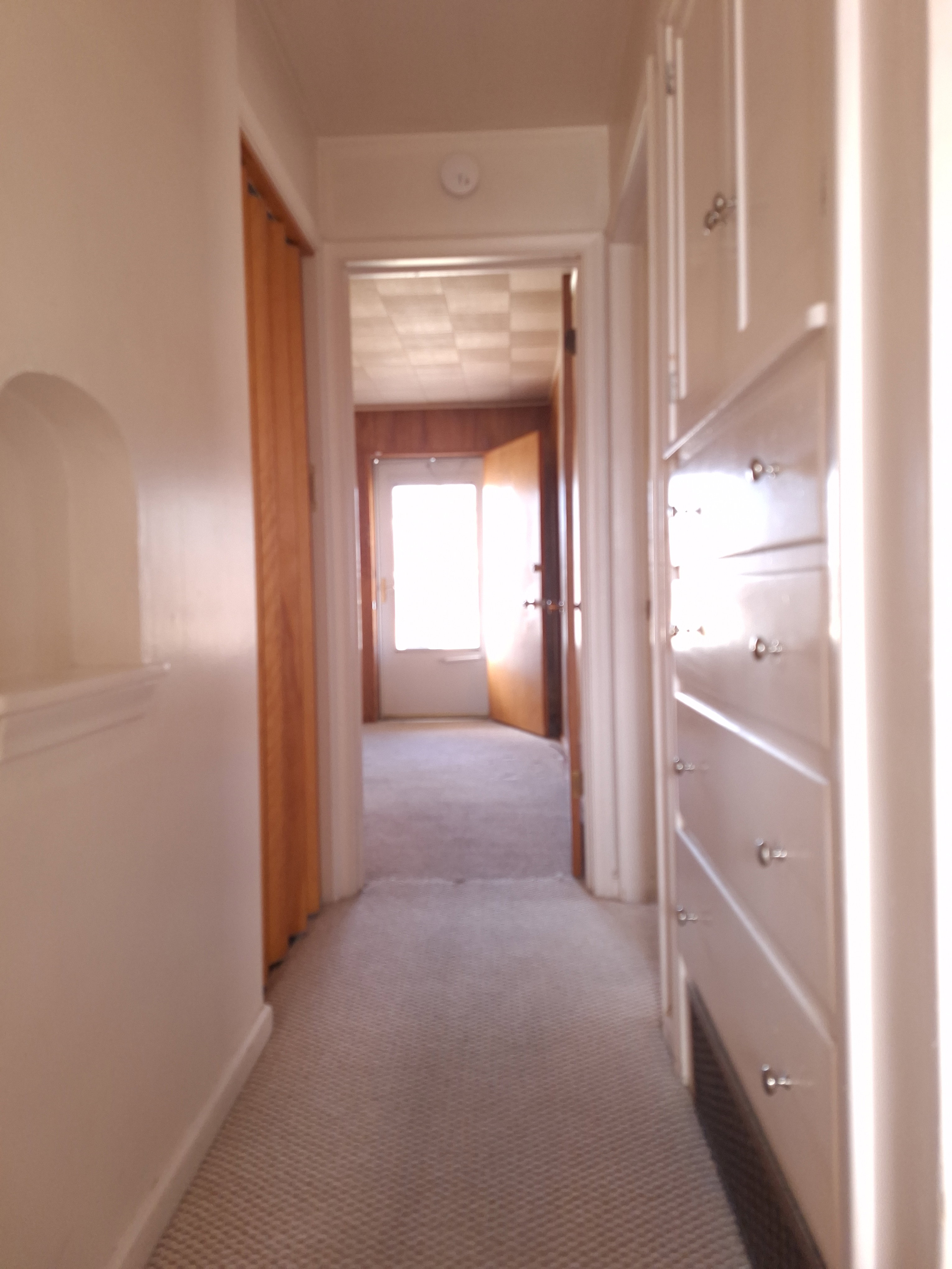 Hallway view from bathroom to front door