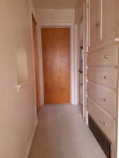 Hallway view from bathroom has built-in storage