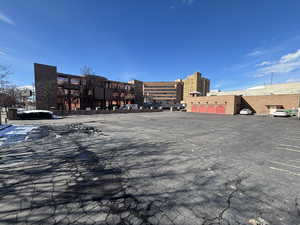 View of commercial property with uncovered parking