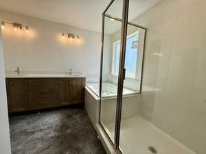 Full bath with a garden tub, double vanity, and a stall shower
