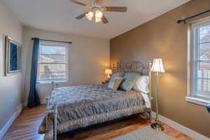 Bedroom featuring wood finished floors and ceiling fan