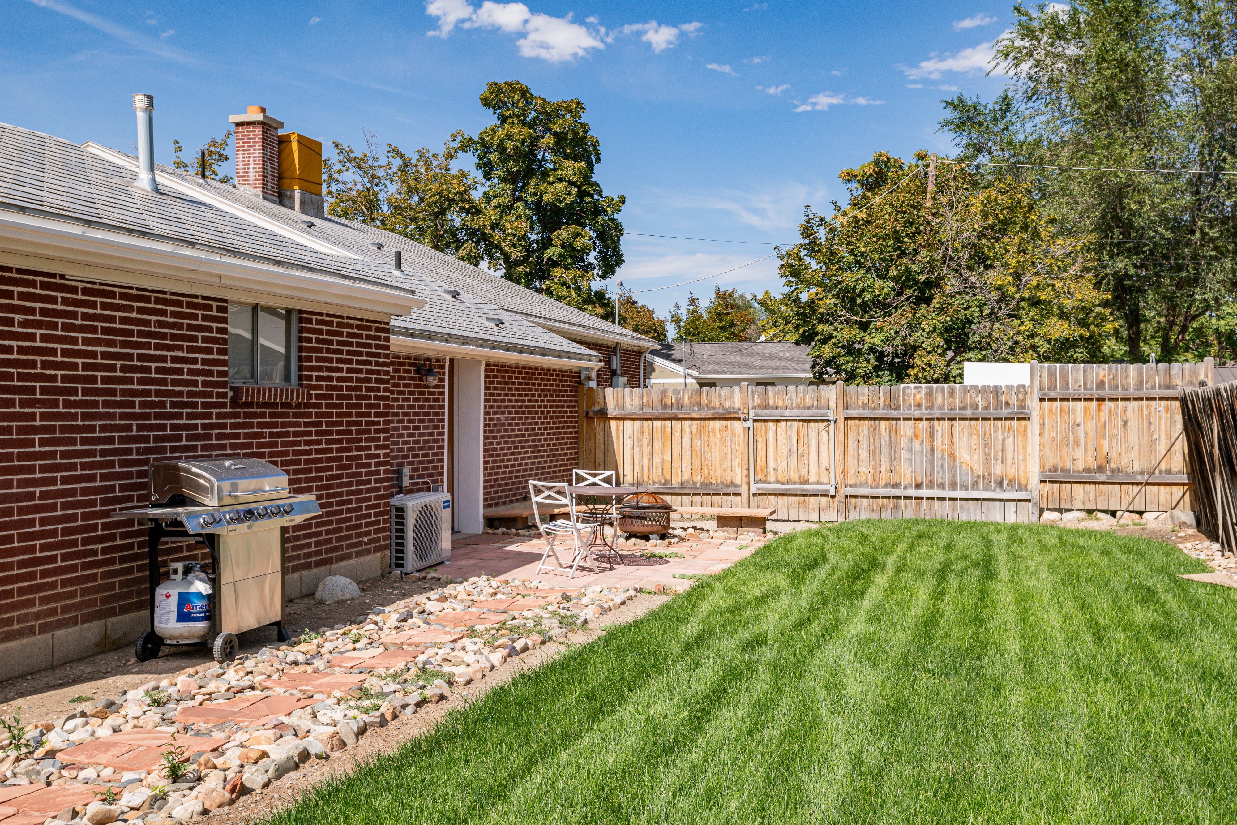 Fenced backyard with a patio area