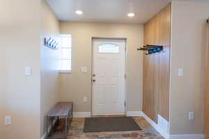 Foyer featuring stone tile floors and recessed lighting