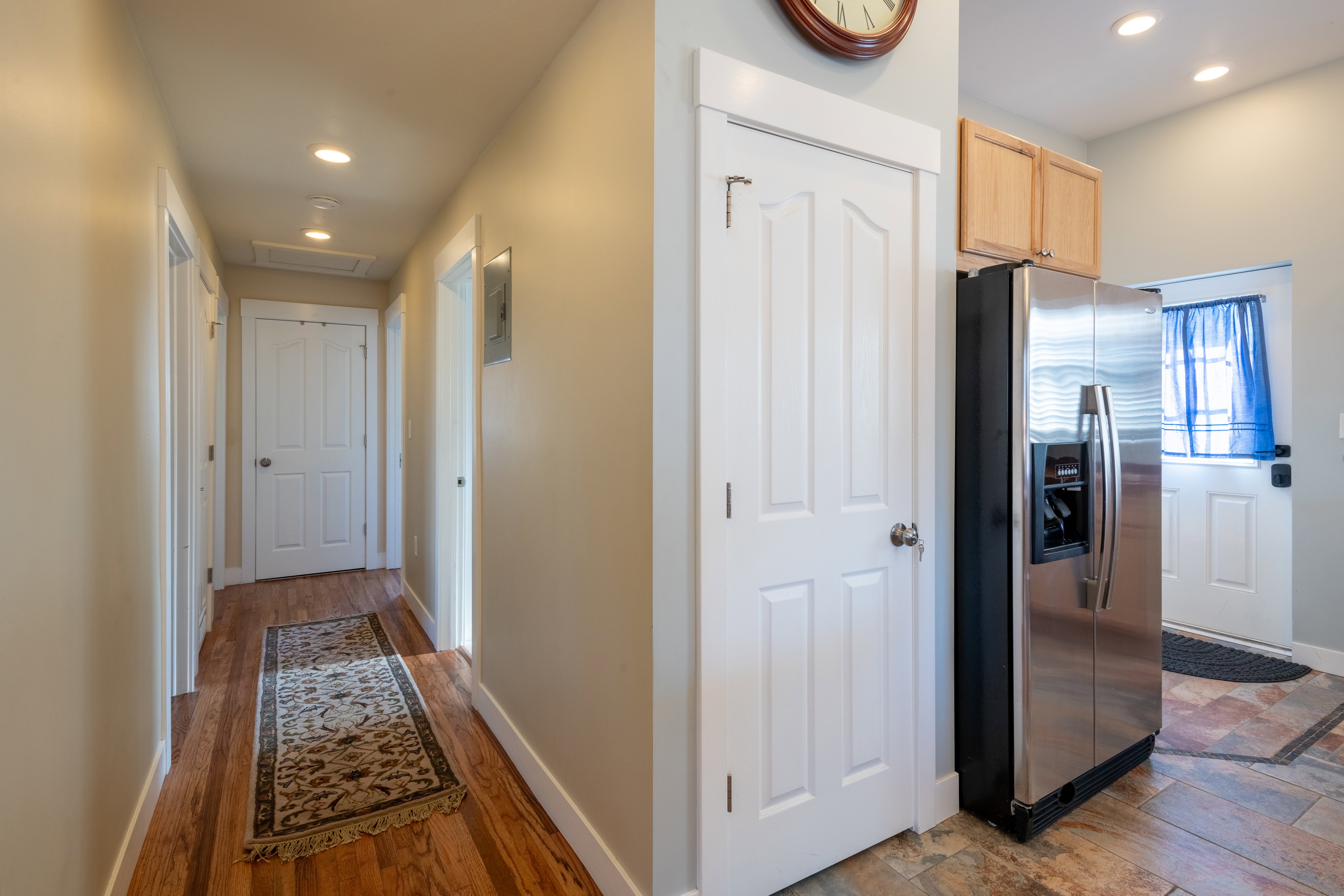 Hall with recessed lighting, dark wood-type flooring, and electric panel