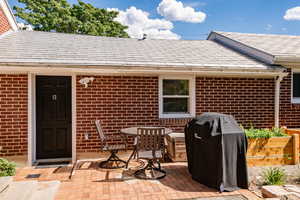 View of patio with area for grilling and outdoor dining space