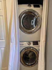 Laundry area featuring stacked washer / dryer