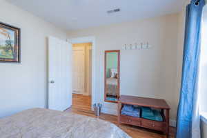 Bedroom featuring light wood-style flooring and baseboards